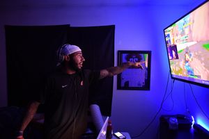 WSU safety Hunter Dale points to a popular live-streamer’s feed showing the video game Fortnite on Aug. 16 at his apartment in Pullman. (Tyler Tjomsland / The Spokesman-Review)