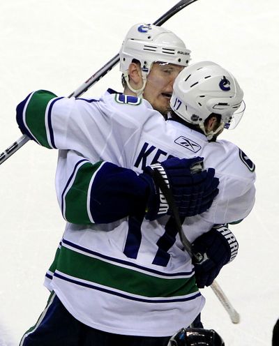 Vancouver center Ryan Kesler celebrates with Christian Ehrhoff after scoring a key third-period goal in win over Nashville. (Associated Press)