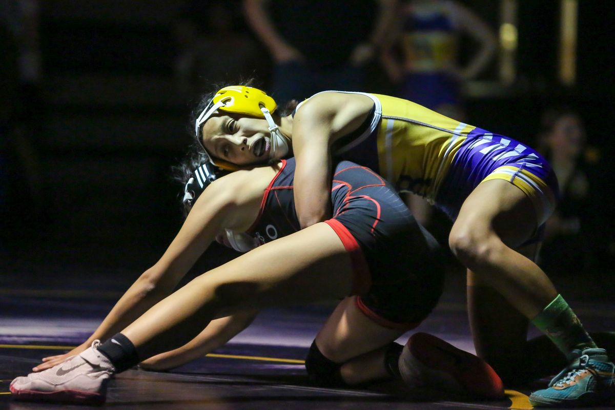 Rogers’ Yadira Covarrubias controls Othello’s Gracie Mendez in the 115-pound class in the first girls wrestling dual hosted by a GSL team Tuesday at Rogers.  (Cheryl Nichols/For The Spokesman-Review)