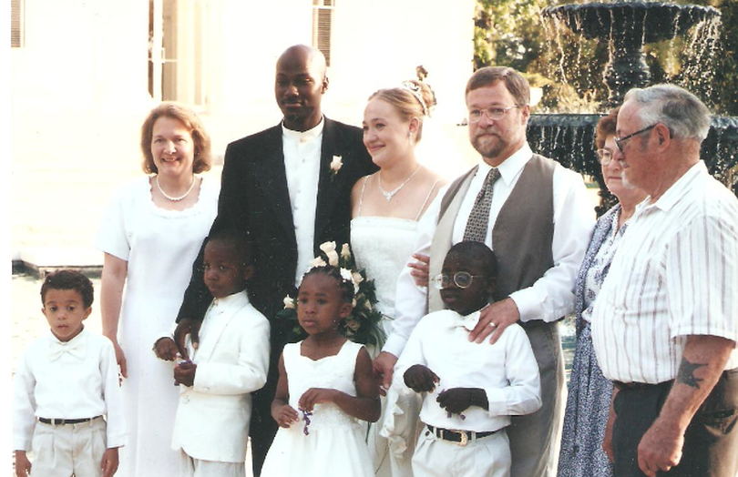 A family photo shows Rachel Dolezal's family at her wedding reception in Jackson, Mississippi on May 21, 2000. Ruthanne and Larry Dolezal identified the people in the photo as: Back row: Ruthanne (mother), Kevin & Rachel, Larry (father), Peggy & Herman (Larry's parents); Front Row, our (Larry and Ruthanne's) adopted children: Ezra, Izaiah, Esther and Zachariah.
 (Courtesy of Dolezal family)