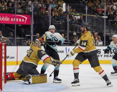 Vegas Golden Knights goaltender Adin Hill (33) loses his stick as teammate Nicolas Hague (14) and the Seattle Kraken’s Kailer Yamamoto (56) vie for the puck in the first period at T-Mobile Arena on Tuesday, Oct. 10, 2023, in Las Vegas.  (Tribune News Service)