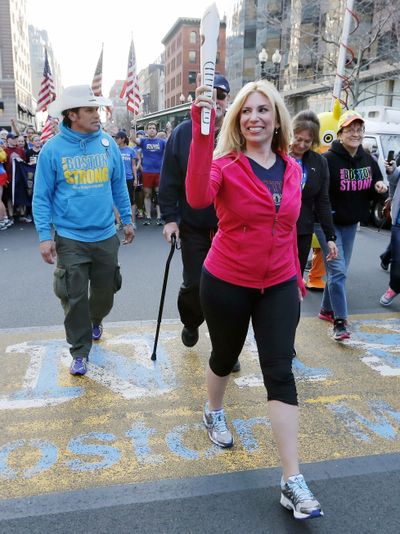 Boston Marathon bombing survivor Heather Abbott crosses the finish line in Boston on Sunday. (Associated Press)