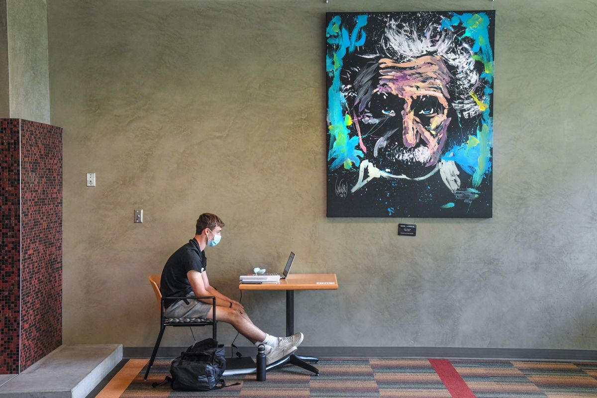 Washington State University freshman Kyle Denton, from Denver, Co., connects via his laptop to his 171 math class while siting in the Compton Union Building quiet lounge on the first day of school, Monday, Aug. 24, 2020, in Pullman, Wash.  (DAN PELLE/THE SPOKESMAN-REVIEW)