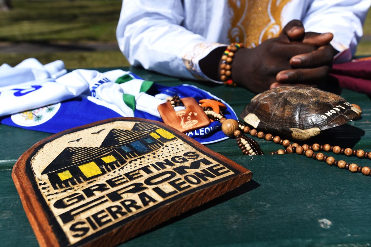 In this April 7, 2016 photo, Usifu Bangura sits with items after returning from his native country, Missoula, Mont. Bangura arrived back in Montana from a month in the small West African country where his mother gave him up for adoption in 2004. (Tommy Martino / Associated Press)