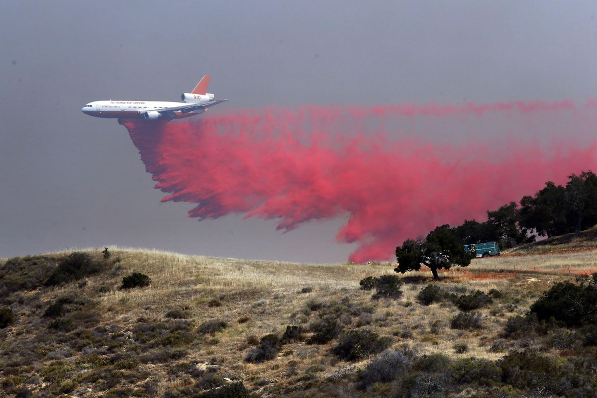 A DC-10 tanker drops fire retardant at a low altitude to help combat a wildfire near Santa Barbara, Calif., on Friday, June 17, 2016. (Nick Ut / Associated Press)