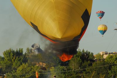 The Wings of Wind hot air balloon catches fire after crashing into power lines during the Albuquerque International Balloon Fiesta on Friday. One man was killed and another was injured. (Associated Press / The Spokesman-Review)
