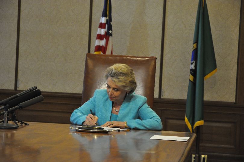 Gov. Chris Gregoire signs SB 6503, the state worker furlough bill, Tuesday afternoon. Although most bill signings are done with supporters in the background to celebrate a new law, no one showed up to claim credit or accept congratulations for the furlough bill. (Jim Camden, Spokesman-Review)