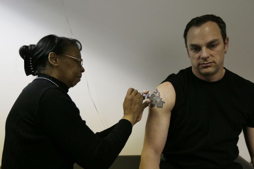 Pam Horn administers the flu vaccine to employee Michael Karolitzky at Philly Flu Shots on Thursday, Jan. 10, 2013, in Philadelphia. The flu season arrived early in the U.S. this year, but health officials and experts say it's too early to say this will be a bad one. Experts say evidence so far is pointing to a moderate flu season - it just looks worse because last year's season was so mild. Flu usually doesn't blanket the country until late January or February. Now, it's already widespread in more than 40 states. That could change when the next government report comes out Friday. (Matt Rourke / Associated Press)