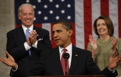 Flanked by Vice President Joe Biden and House Speaker Nancy Pelosi, the president greets Congress. (Associated Press / The Spokesman-Review)