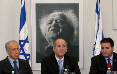 
At a Cabinet meeting Monday in Jerusalem, Israeli Prime Minister Ehud Olmert is flanked by Vice Premier Shimon Peres, left, and Cabinet Secretary Israel Maimon in front of a picture of Israel's first prime minister, David Ben-Gurion. 
 (Associated Press / The Spokesman-Review)