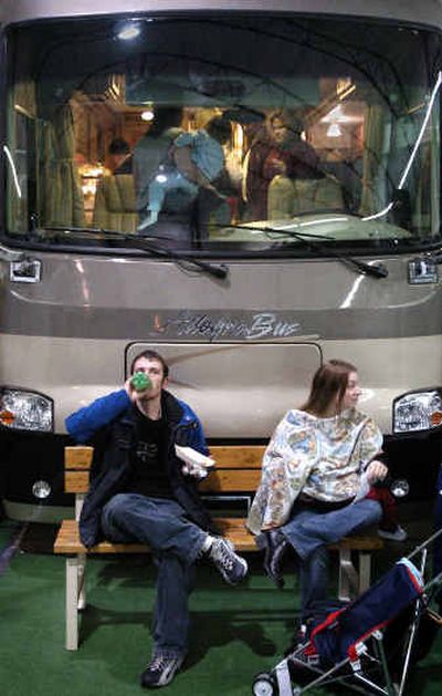 
Richard Yurian and his girlfriend, Taresa Tindall of Moses Lake, take a break on a bench in front of a $270,000 motor home, on sale at the RV Show for a mere $227,000, at the Spokane Fair and Expo Center Saturday afternoon. 
 (Holly Pickett / The Spokesman-Review)