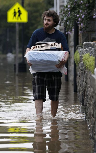 Dustin Campbell evacuates Port Deposit, Md., on Thursday as the Susquehanna River continues to rise. (Associated Press)