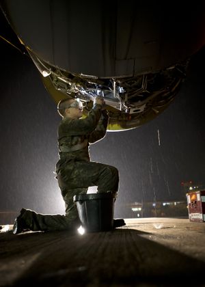 On the flight line at the Manas Transit Center in Kyrgyzstan, Dustin Harder, a jet engine mechanic with the 141st Washington Air National Guard Air Refueling Wing, cleans the fuel filters on a engine of a KC-135R Stratotanker. (Colin Mulvany / The Spokesman-Review)