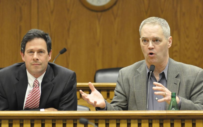 OLYMPIA -- House Appropriations Chairman Ross Hunter (right) explains a point while Senate Ways and Means Committee Chairman Andy Hill listens during the economic forecast which suggests some $327 million extra in revenue for the state's general fund in 2015-17 (Jim Camden/Spokesman-Review)