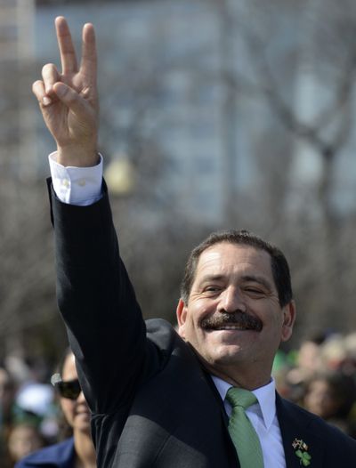 Chicago mayoral candidate Jesus “Chuy” Garcia gives the victory sign Saturday while walking during the St. Patrick’s Day parade in Chicago. (Associated Press)