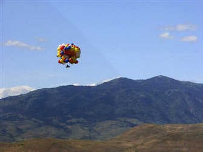 Kent Couch, 48, flies across Oregon on Saturday in his lawn chair rigged with helium-filled balloons. Associated Press
 (Associated Press / The Spokesman-Review)