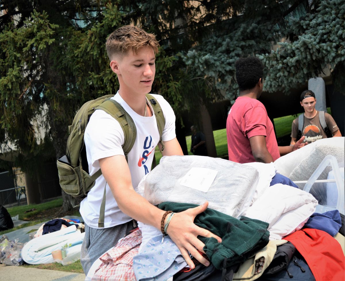 Washington State University freshman Parker Saben loads a cart with his belongings Friday, Aug. 13, 2021, as he moves into Global Scholars Hall on the WSU Pullman campus.  (Greg Mason / The Spokesman-Review)