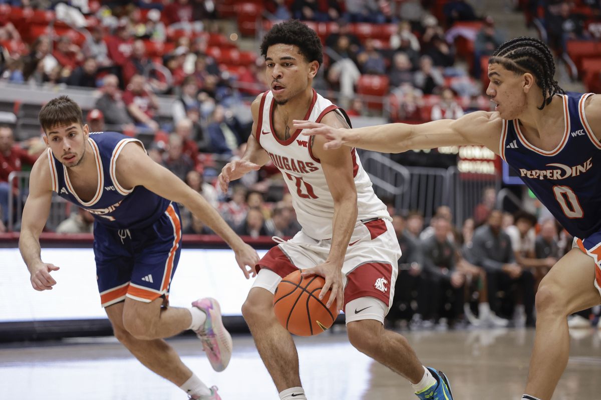 Washington State guard Ace Glass (21) drives between Pepperdine guard Styles Phipps (0) and forward Vladimir Sudar (7) in the first half on Saturday, Jan. 24, 2026, at Beasley Coliseum in Pullman, Wash.  (Geoff Crimmins/For The Spokesman-Review)
