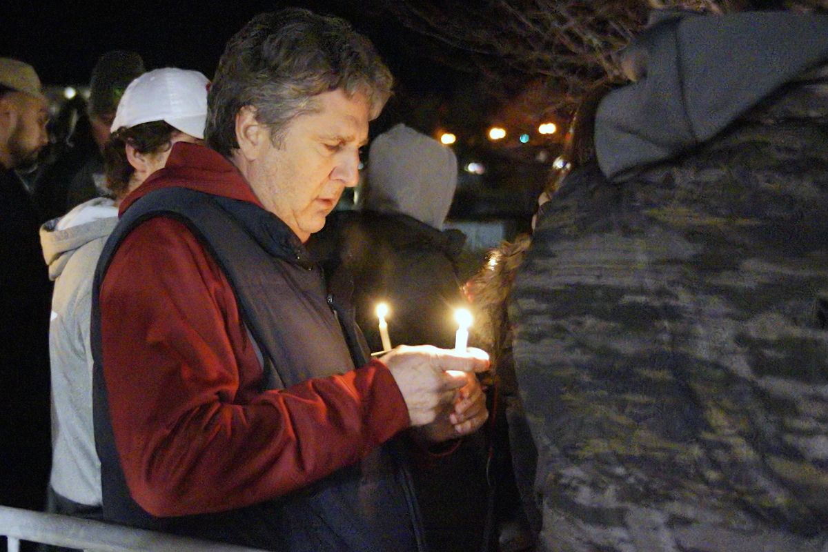 Washington State coach Mike Leach holds a candle during a memorial service for quarterback Tyler Hilinski, Friday, Jan. 19, 2018, in Pullman, Wash. (Kai Eiselein / Moscow-Pullman Daily News via AP)