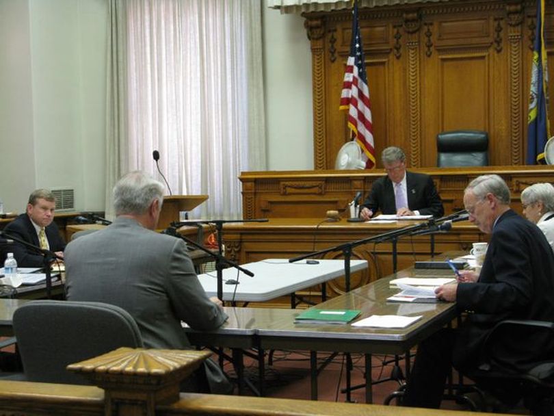 Idaho's state Land Board, including Attorney General Lawrence Wasden, left, listens to a presentation from state endowment investment manager Larry Johnson on Tuesday. The board voted unanimously to set public school distributions from the endowment fund for next year at this year's level, less a special $22 million boost schools are getting this year. (Betsy Russell)