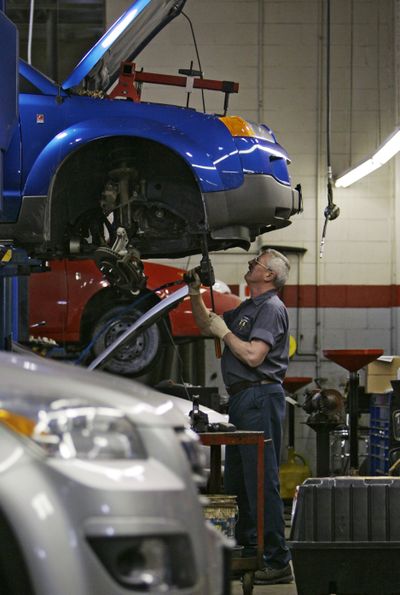 In this 2009 photo, mechanic Tom Lill works on a Saturn Vue at Saturn of North Olmsted in North Olmsted, Ohio. (File Associated Press / Associated Press)
