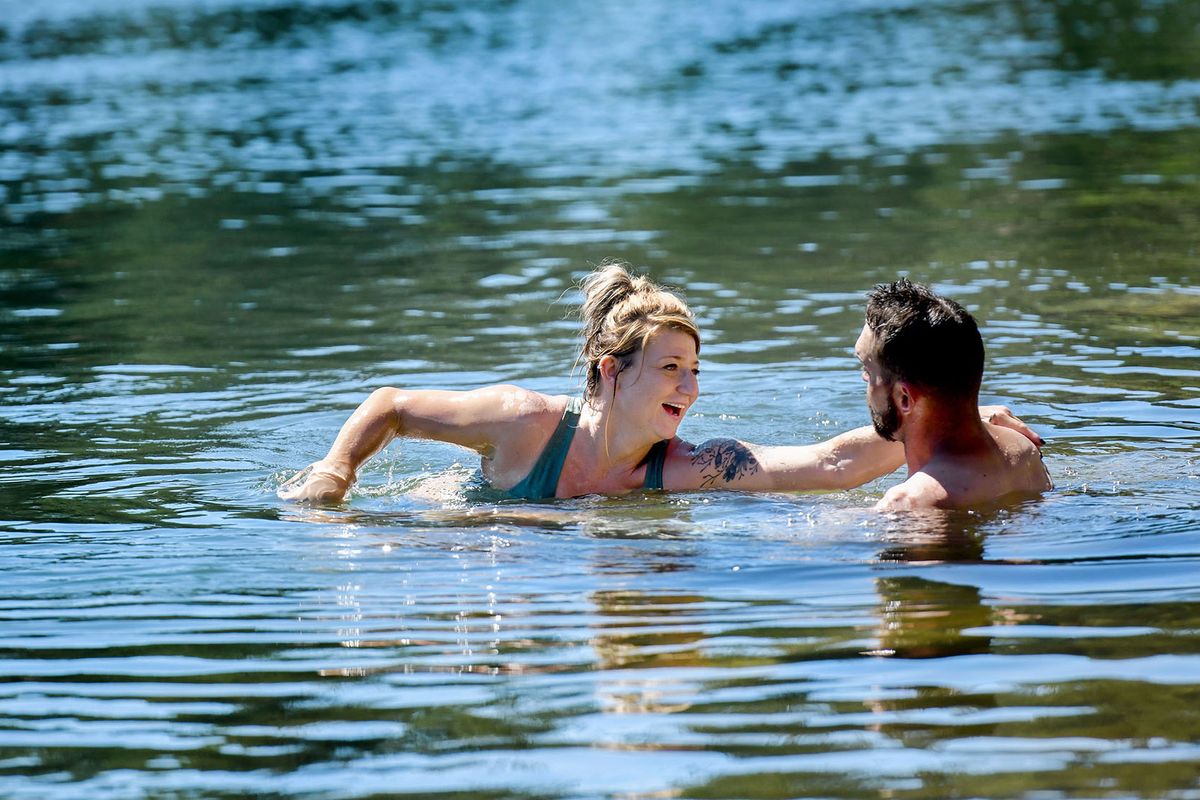 Ashley Nirk and Cody Moreland stay cool while swimming in the Spokane River at Corbin Park in Post Falls on Monday. (KATHY PLONKA/THE SPOKESMAN-REVIEW)