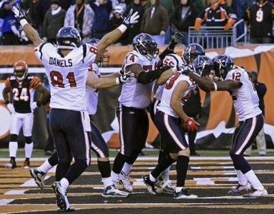 Texans WR Kevin Walter, with football, is mobbed by teammates after catching the winning touchdown pass with 3 seconds remaining. (Associated Press)