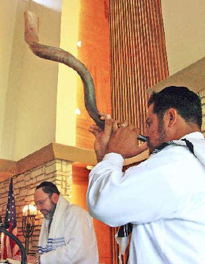 
Rabbi Frank Joseph reads while Fernando Russek blows the shofar last year during the Rosh Hashana service at Temple Beth Israel,  in Harlingen, Texas. 
 (Associated Press / The Spokesman-Review)