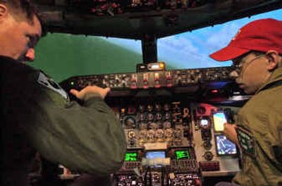 Pilot Kevin Littlemore teaches Jason Stolz, 13, how to stay level during a session in the KC-135 flight simulator at Fairchild Air Force Base Wednesday afternoon. Stolz was one of two children who became honorary pilots through the Pilot for a Day program.
(Holly Pickett / The Spokesman-Review)