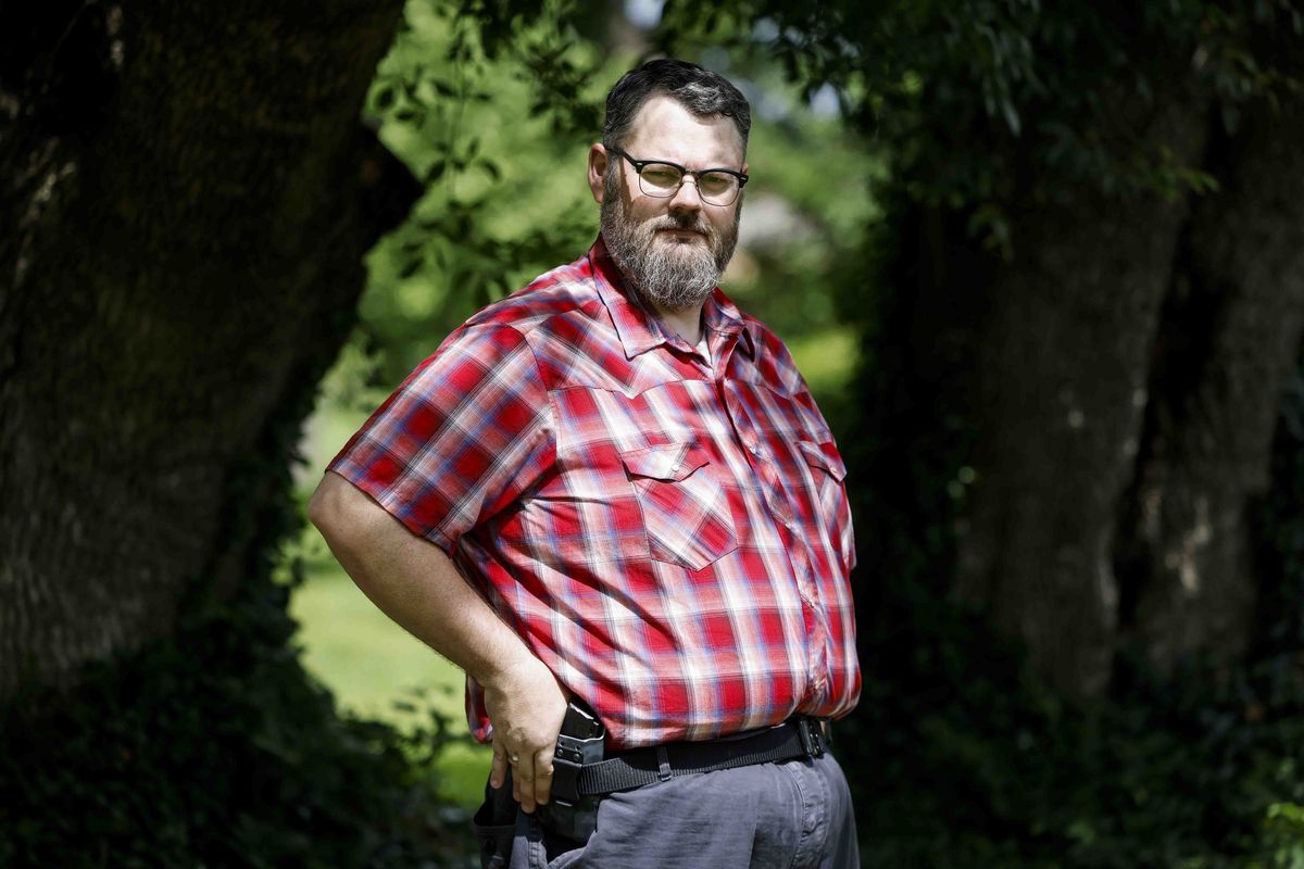 Duncanville High School Collegiate Academy teacher Glynn Wilcox poses for a portrait carrying his 9mm handgun on Wednesday, June 1, 2022, at his residence in Dallas. He is a gun owner but can't support the effort to arm more teachers in schools after the Uvalde shooting. (Shafkat Anowar/The Dallas Morning News/TNS)  (Shafkat Anowar/The Dallas Morning News/TNS)