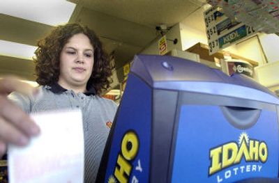 
Ashley Dotts, a clerk at the Super 24 store in Post Falls, tears off another Powerball ticket for a customer Tuesday as Powerball fever was building around a $240 million jackpot.
 (Jesse Tinsley / The Spokesman-Review)