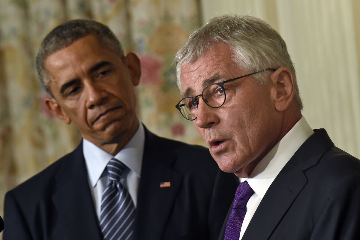 President Barack Obama looks to Defense Secretary Chuck Hagel as he talks about his resignation during an event in the White House on Monday. (Associated Press)