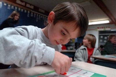 
Nick Mandearo, 4, joins in a game of word bingo with his older brother and friends at Borah Elementary's Dinner and a Book night Tuesday. 
 (Jesse Tinsley / The Spokesman-Review)