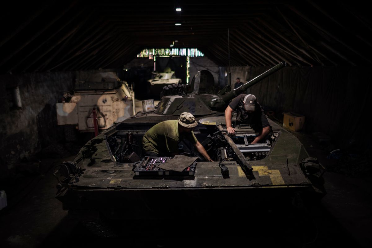 Members of the 35th Marine Brigade repair a Soviet-era infantry fighting vehicle, in the Donetsk region in southern Ukraine, July 29, 2023. Behind the thousands of Ukrainian troops fighting the counteroffensive are engineers and technicians who perform an essential, and often dangerous, job. (Diego Ibarra Sanchez/The New York Times)