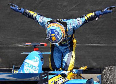 
Renault's Fernando Alonso, from Spain, bows on his car after winning the Canadian Grand Prix.
 (Associated Press / The Spokesman-Review)