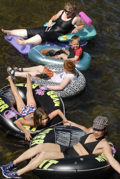 
With temperatures reaching into the high 80s, from top, Jamie Tabino, Lincoln Tabino, Spencer Tabino, Emma Randolph and Mary Randolph float through Pine River Park in north Spokane County on Tuesday. 
 (Dan Pelle / The Spokesman-Review)
