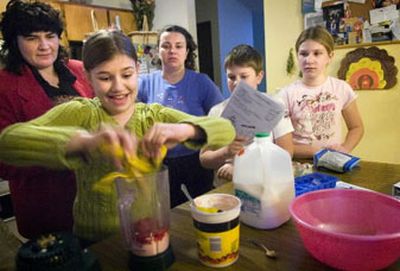 Santa Kaskevica, 10, puts a banana in a blender while Tatyana Bistrevsky, far left, teaches the Kaskevica family how to make a fruit smoothie at their Spokane home. The health district has released the results of a survey assessing the Slavic community's health.
(Holly Pickett/The Spokesman Review / The Spokesman-Review)