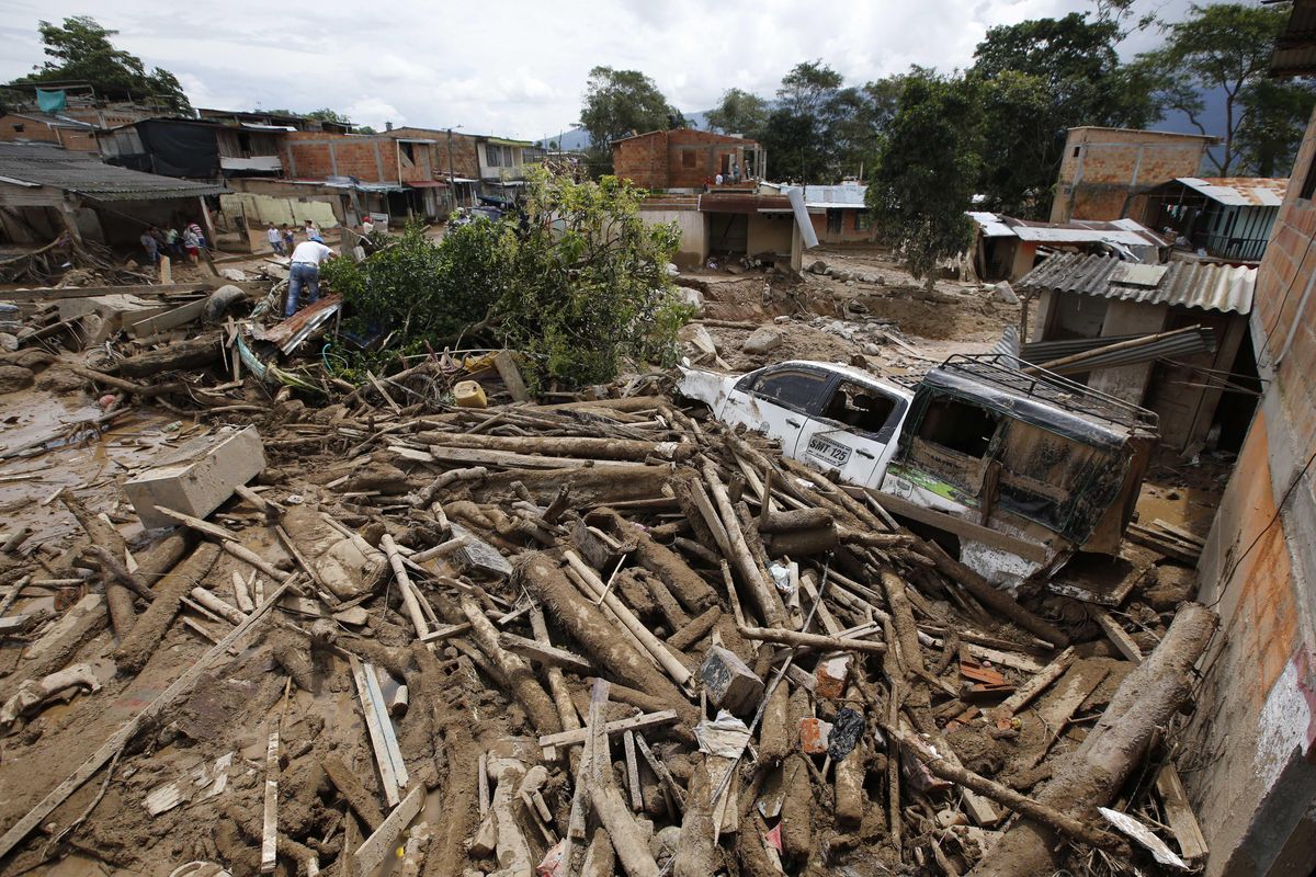 Tree trunks and mud cover a street in Mocoa, Colombia, Sunday. A grim search for the missing resumed at dawn Sunday in southern Colombia after surging rivers sent an avalanche of floodwaters, mud and debris through a city, killing at least 200 people and leaving many more injured and homeless. (Fernando Vergara / Associated Press)