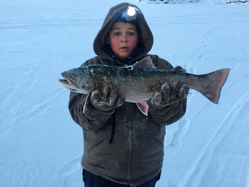 Kazen Cromar, 10, poses with his 22-inch-long Idaho catch-and-release record brook trout caught in December 2016 at Henry’s Lake.  (Courtesy)