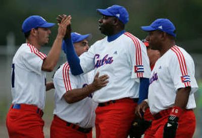
Cuba's players congratulate pitcher Pedro Luis Lazo after a win over Venezuela. Associated Press
 (Associated Press / The Spokesman-Review)