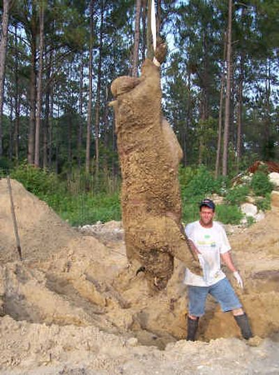 
Chris Griffin, 31, poses beside the half-ton wild hog he shot near Alapaha, Ga., in a June 17 photo. 
 (File/Associated Press / The Spokesman-Review)