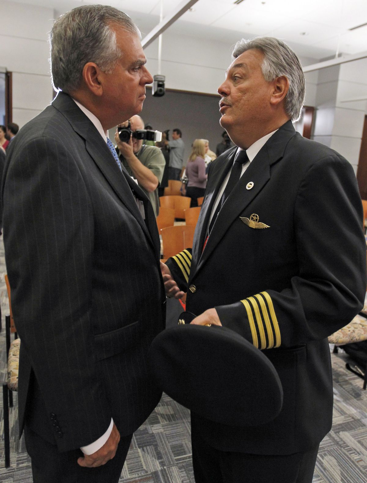 Transportation Secretary Ray LaHood, left, talks with Captain John H. Prater, president of the Air Line Pilots Association, after a  news conference in Washington on Friday to announce proposed rule changes.  (Associated Press)