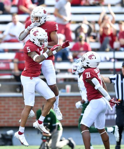 Washington State defensive backs Derrick Langford Jr. (5), Jaden Hicks (25) and Adrian Shepherd celebrate after Hicks intercepted a Colorado State pass during the second half of a college football game on Sept. 17 at Gesa Field in Pullman.  (Tyler Tjomsland/The Spokesman-Review)