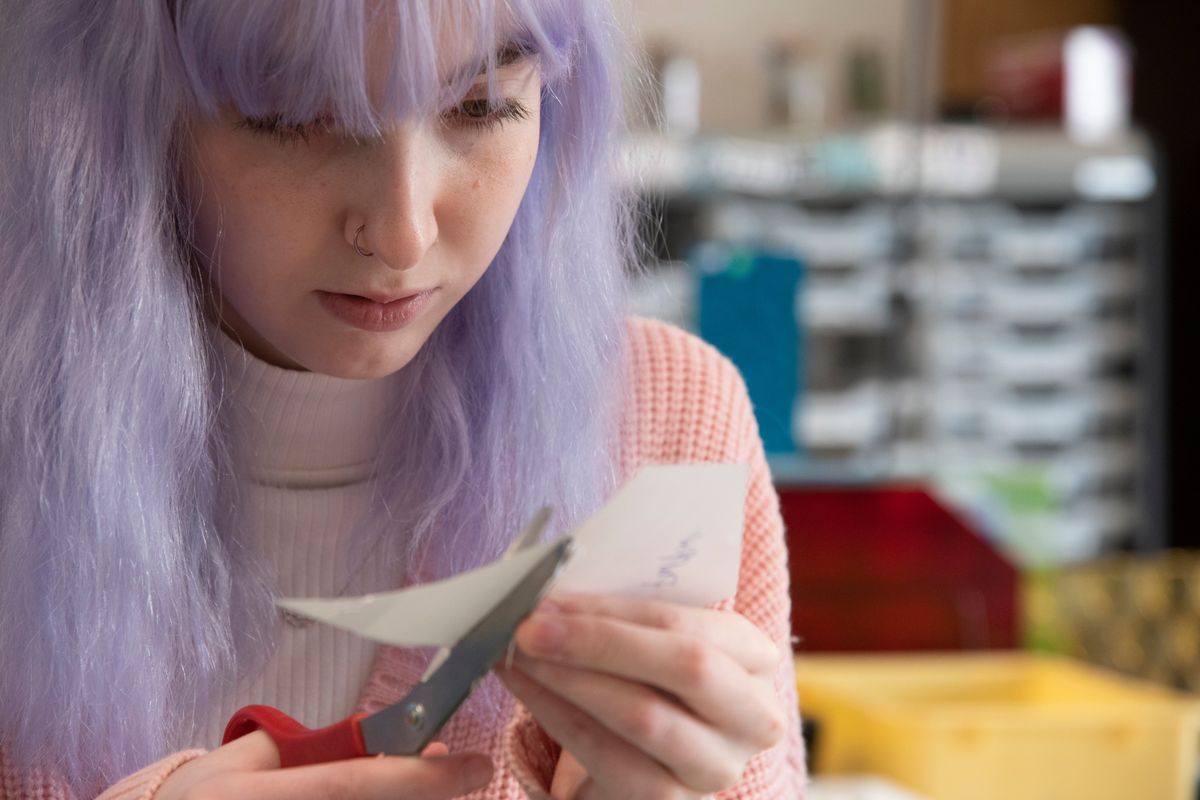 Rachel Peterson, 18, carefully cuts out pieces of the paper pattern for a stain glass panel in her advanced art class at On Track Academy on April 18.  (Jesse Tinsley/THE SPOKESMAN-REVIEW)