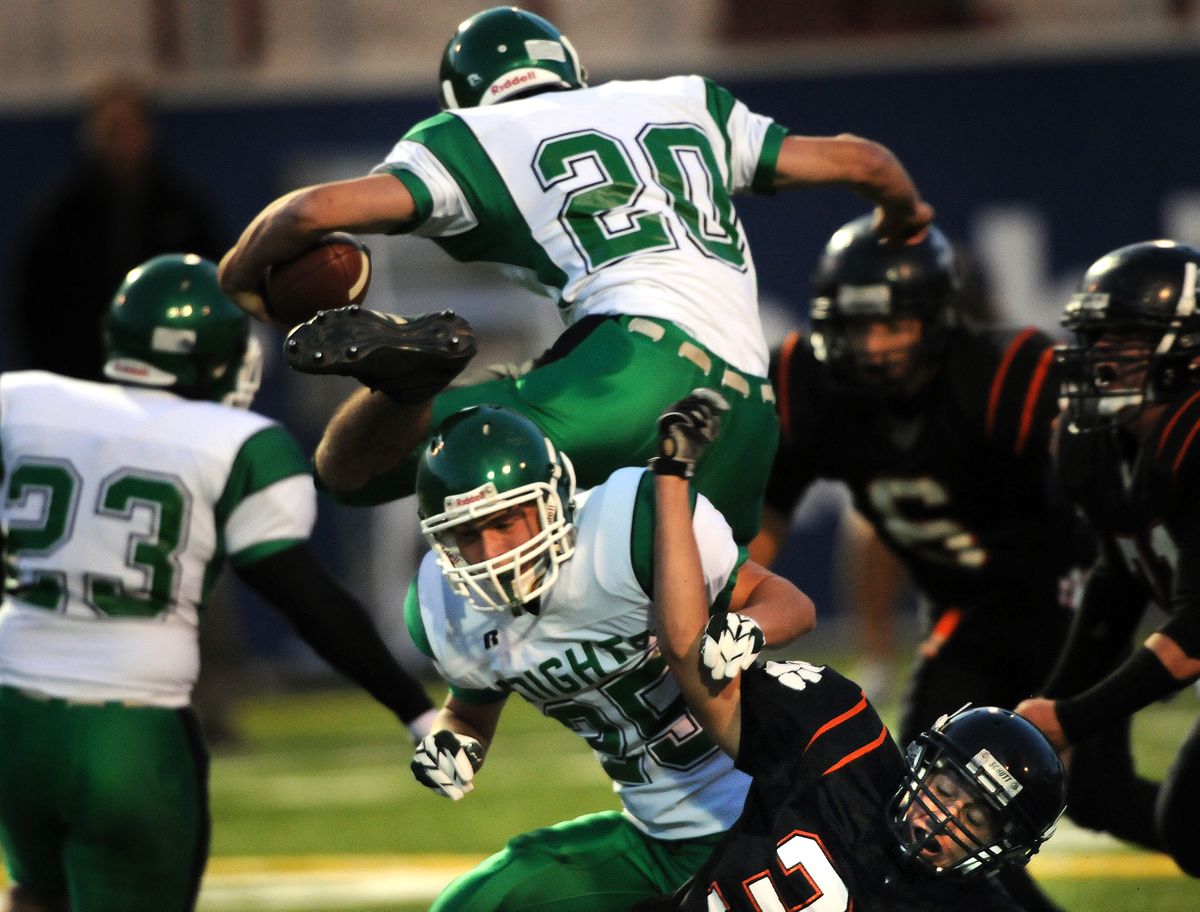 East Valley’s Nick Bellomy jumps over teammate John Gjendem during the first half. (Rajah Bose / The Spokesman-Review)