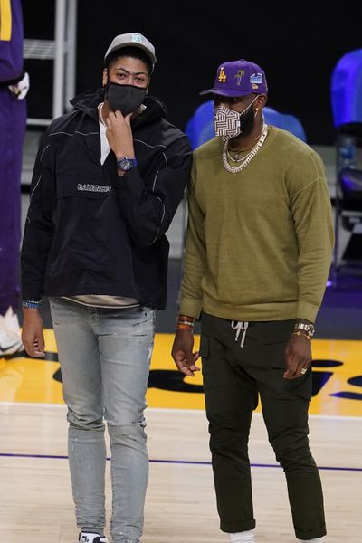 Los Angeles Lakers injured players Anthony Davis, left, and LeBron James talk on the court during a timeout during the first half of an NBA basketball game against the Utah Jazz Monday, April 19, 2021, in Los Angeles.  (Associated Press)