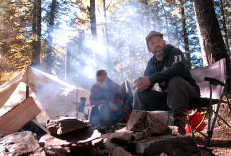 Hunting guide Bill Gregg, right, and Myndy Shattel wait for a hunting client at their elk camp at Shoshone Creek in the Coeur d'Alene River drainage. 
 (Jesse Tinsley / The Spokesman-Review)