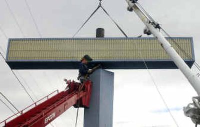 
Chip Worley, a worker with Epcon Sign Co., removes the sign at Olde European Breakfast House & Bistro on Sprague Avenue in Spokane Valley. The restaurant replaced its old sign. 
 (Liz Kishimoto / The Spokesman-Review)