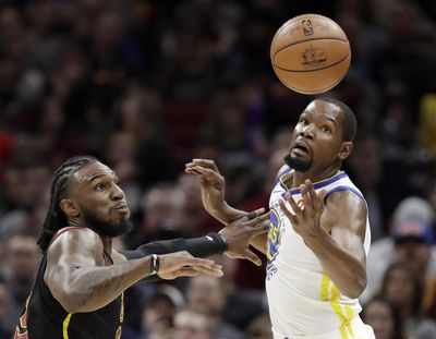Cleveland’s Jae Crowder, left, knocks the ball loose from Golden State’s Kevin Durant on Monday night in Cleveland. (Tony Dejak / Associated Press)