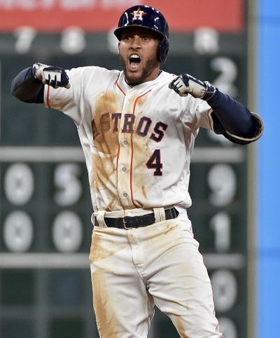 Houston’s George Springer celebrates his two-run double in the sixth inning against the Seattle Mariners. (Eric Christian Smith / Associated Press)